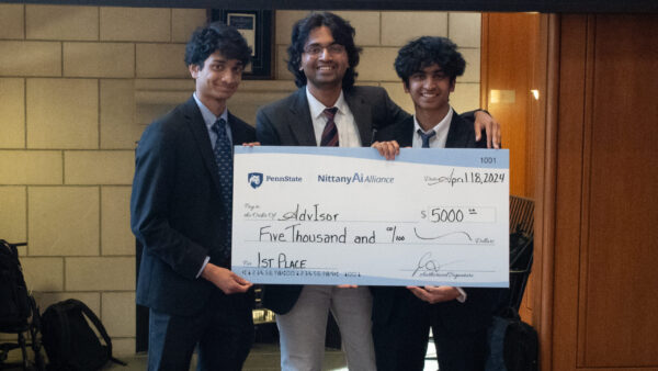The AdvIsor team poses with their first place award check.