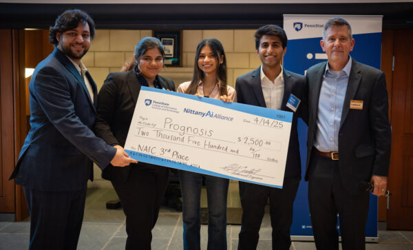 Prognosis team members pose with their award check.