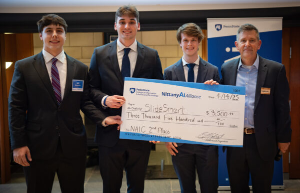 SlideSmart team members pose with their award check.
